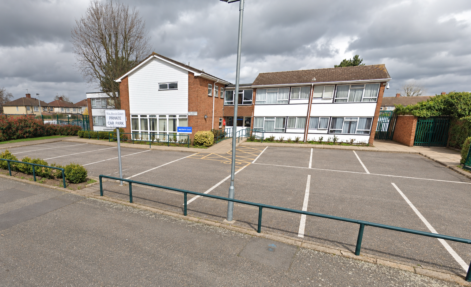 Exterior of Will Perrin Court sheltered housing hostel on Guysfield Drive in Rainham, with the entrance and front parking area